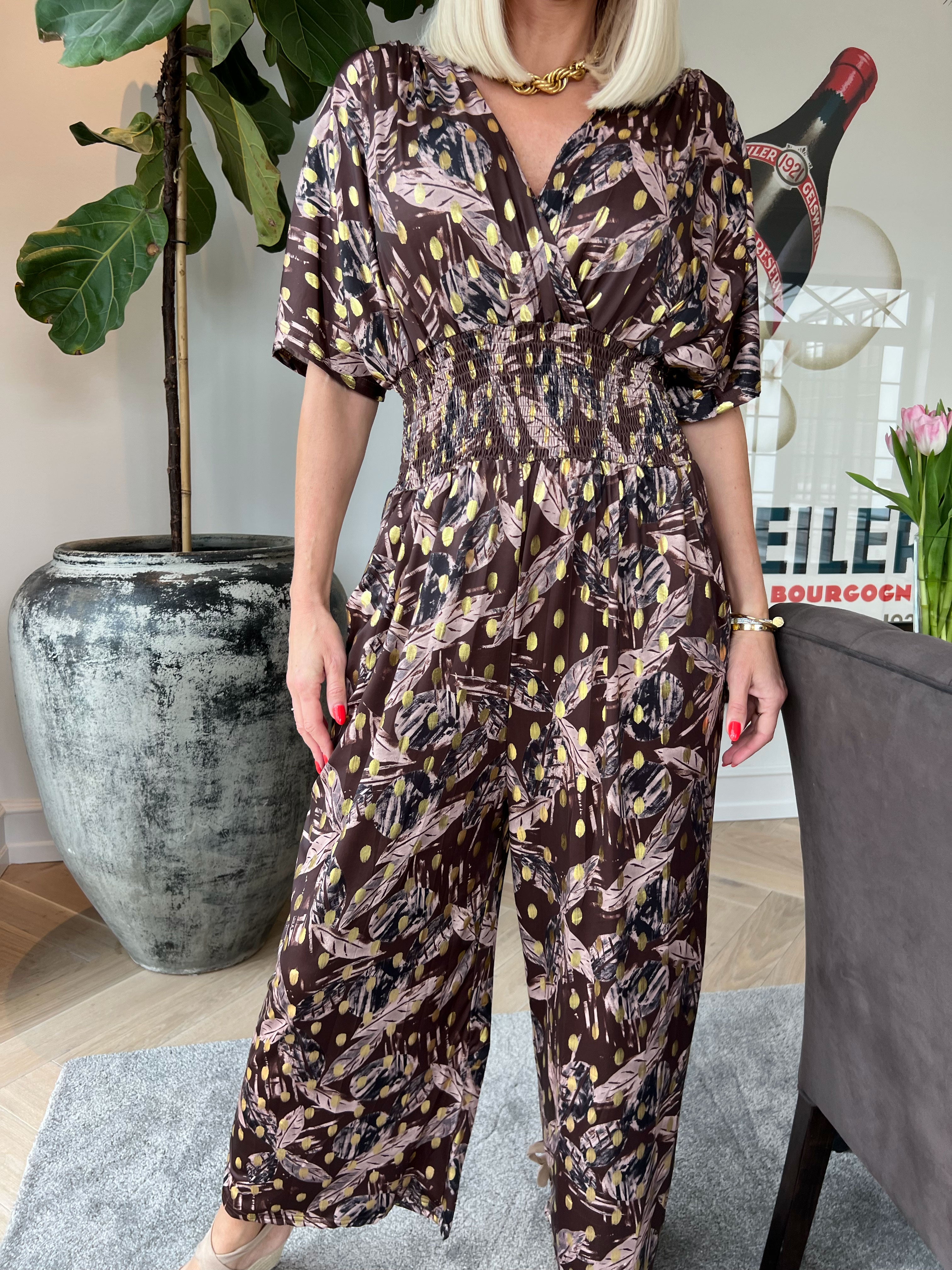 Pams Leafage Jumpsuit - Elastisk jumpsuit i lövmönster med guldfärgade tofsar